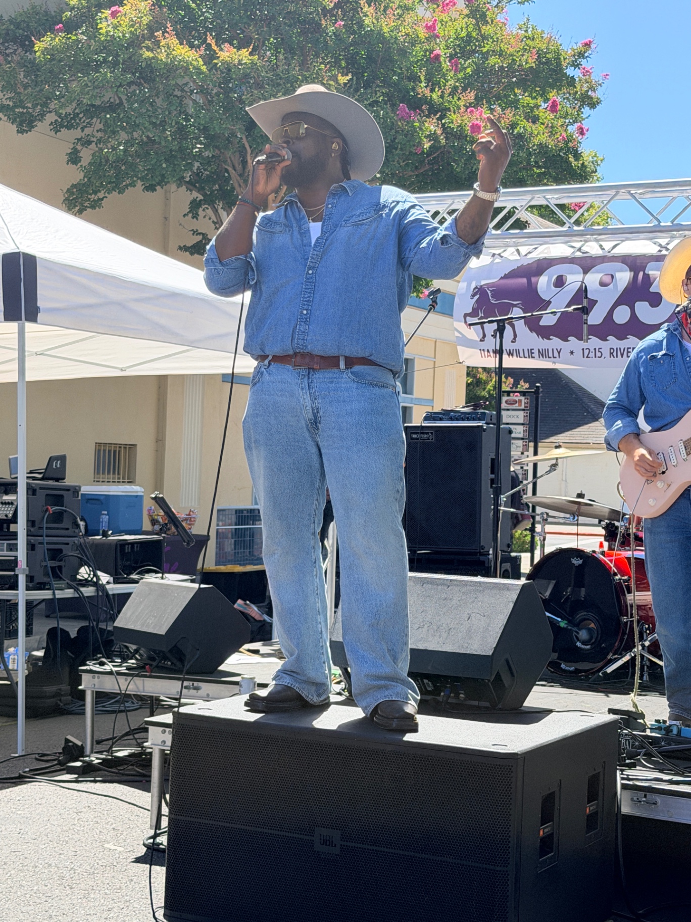 Willie Nilly singer standing on a speaker belting into the mic