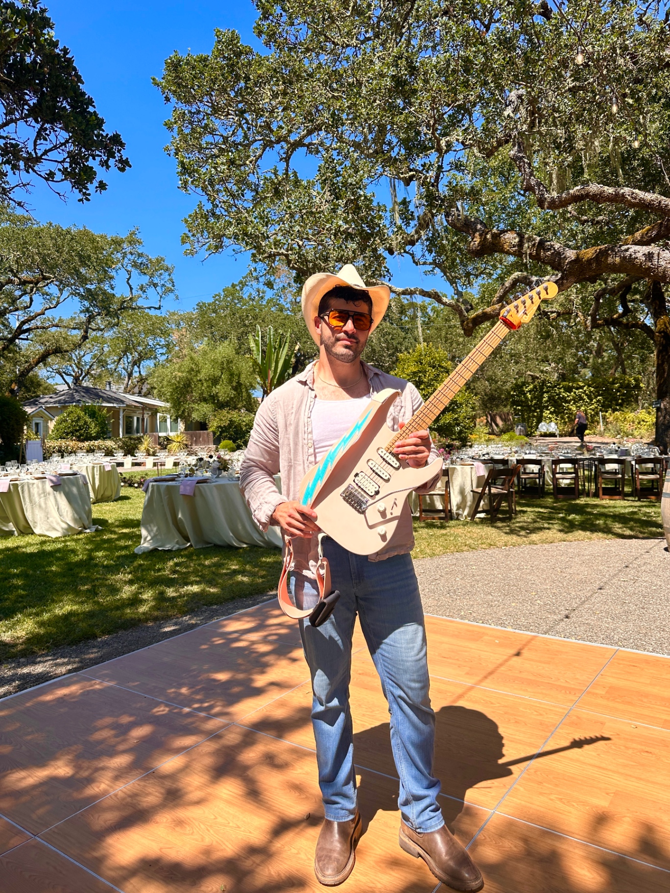 Andrew with his lightning bolt guitar under an oak tree