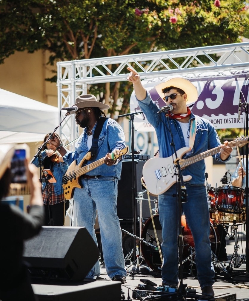 Willie Nilly rocking a festival stage with guitars and fiddle