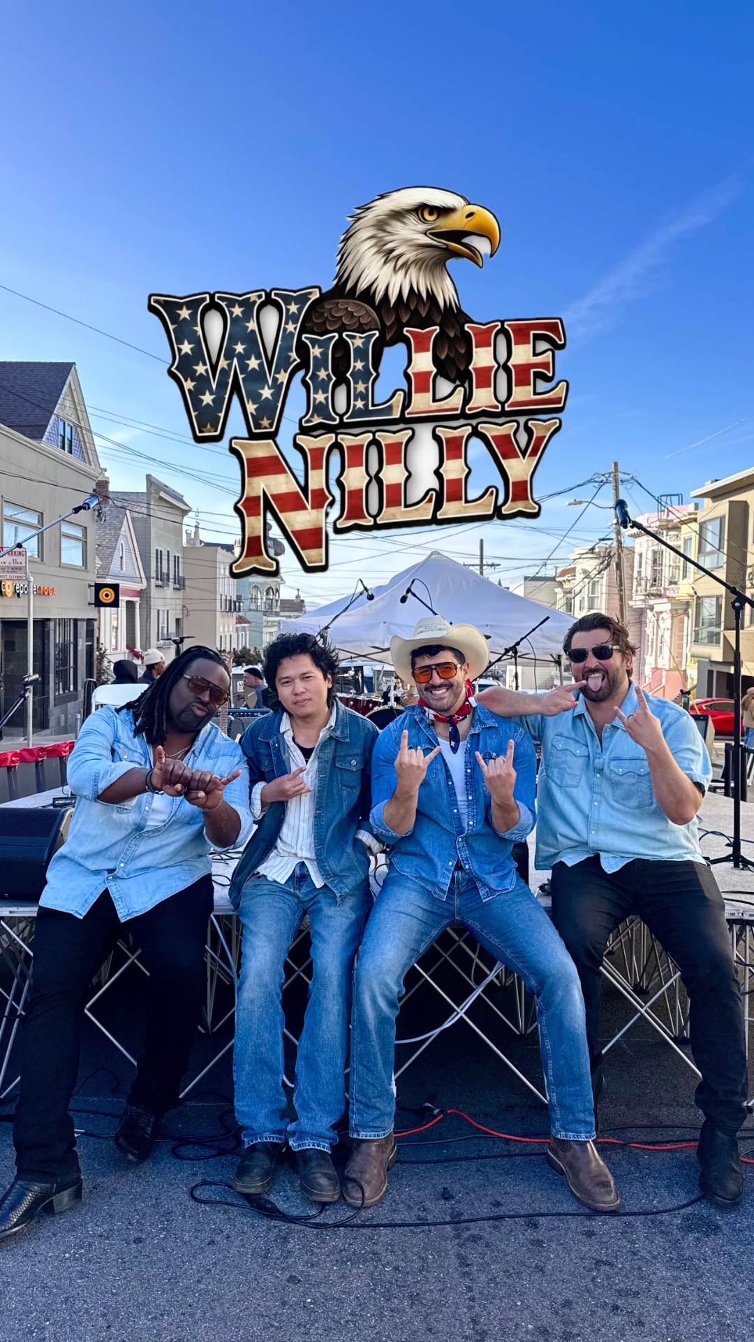 Willie Nilly sitting on stage at a San Francisco street fair